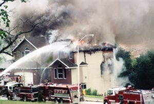 Image of a burning home. Home Living Construction can quickly repair fire and smoke damage.